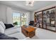 Bright living room with a couch and sliding door view of the water, with white carpet and modern lighting at 4959 58Th S Ave, St Petersburg, FL 33715