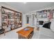 Living room area with large decorative shelving, white walls, and a comfortable sitting area at 4959 58Th S Ave, St Petersburg, FL 33715
