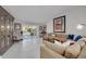 Bright living room with tile floors, comfortable seating, and sliding glass doors to the outdoor pool area at 4959 58Th S Ave, St Petersburg, FL 33715