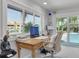 A home office featuring a large window view of the pool and palm trees at 4959 58Th S Ave, St Petersburg, FL 33715