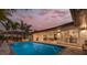 A luxurious outdoor pool and covered patio with dining and lounge area, perfect for entertaining at 4959 58Th S Ave, St Petersburg, FL 33715