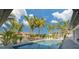 Sparkling pool surrounded by lush palm trees and landscaping, creating a private backyard oasis at 4959 58Th S Ave, St Petersburg, FL 33715