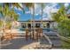 Outdoor seating area next to the pool and patio, complete with lounge chairs, ideal for relaxation and socializing at 4959 58Th S Ave, St Petersburg, FL 33715