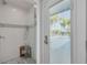 A glass shower with a mosaic tile accent and a view to the pool at 4959 58Th S Ave, St Petersburg, FL 33715