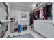 A well-organized walk-in closet with custom shelving, storage, and a gray cushioned bench at 4959 58Th S Ave, St Petersburg, FL 33715