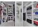 A walk-in closet with custom shelves and storage for clothes and shoes at 4959 58Th S Ave, St Petersburg, FL 33715
