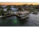 Beautiful aerial view of a waterfront property featuring a boat lift, dock, and in-ground swimming pool at 5105 W Longfellow Ave, Tampa, FL 33629