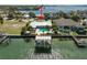 Waterfront home featuring a private dock, boat lift, and swimming pool on a sunny day at 5105 W Longfellow Ave, Tampa, FL 33629