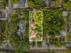 Aerial view of the property surrounded by lush greenery and other residential homes at 5604 N Cherokee Ave, Tampa, FL 33604