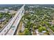 Aerial view of the property near highway access and surrounded by lush greenery at 5604 N Cherokee Ave, Tampa, FL 33604