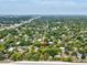 Aerial view of the property nestled among lush trees in a residential neighborhood at 5604 N Cherokee Ave, Tampa, FL 33604