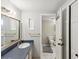 The bathroom features a sink and vanity with an open door to the toilet at 5604 N Cherokee Ave, Tampa, FL 33604