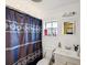 Bathroom featuring a shower with a stylish curtain, vanity, and bright natural light at 5604 N Cherokee Ave, Tampa, FL 33604