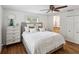 This bedroom features hardwood floors, a ceiling fan, and a neutral palette at 5604 N Cherokee Ave, Tampa, FL 33604