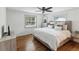 Bright bedroom with hardwood floors and soft natural light from the windows at 5604 N Cherokee Ave, Tampa, FL 33604