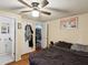 Bedroom with hardwood floors, a ceiling fan, and access to an ensuite bathroom at 5604 N Cherokee Ave, Tampa, FL 33604