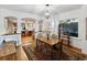 Open dining room with hardwood floors and an archway leading to the kitchen at 5604 N Cherokee Ave, Tampa, FL 33604