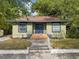 Charming single-story home with a quaint front yard and inviting blue front door at 5604 N Cherokee Ave, Tampa, FL 33604