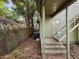 Back entrance with stone steps, metal stairway, and lush surroundings providing privacy at 5604 N Cherokee Ave, Tampa, FL 33604