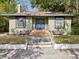 Charming single-story home with blue double-door entrance and well-manicured lawn at 5604 N Cherokee Ave, Tampa, FL 33604