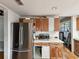 Bright kitchen with stainless steel refrigerator, white countertops and tile floor at 5604 N Cherokee Ave, Tampa, FL 33604