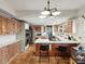 Spacious kitchen with a center island, stainless steel appliances, and terracotta tile flooring at 5604 N Cherokee Ave, Tampa, FL 33604