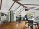 A spacious kitchen with hardwood floors, exposed beams, and dining space at 5604 N Cherokee Ave, Tampa, FL 33604