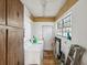 Laundry room with white washer and dryer and a window for natural light at 5604 N Cherokee Ave, Tampa, FL 33604