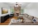 Comfortable living room with a stone fireplace, a plush sectional, and hardwood floors at 5604 N Cherokee Ave, Tampa, FL 33604