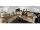 The living room has neutral walls and is furnished with guitars and a comfortable beige sectional sofa at 5604 N Cherokee Ave, Tampa, FL 33604