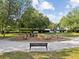 Community playground featuring tunnel, rock structure, benches, and mature trees for children to enjoy at 5604 N Cherokee Ave, Tampa, FL 33604