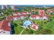 Scenic aerial view showcases the community pool and clubhouse, surrounded by lush landscaping and beautiful waterfront views at 6059 Bahia Del Mar Blvd # 134, St Petersburg, FL 33715