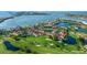 Amazing aerial view showcasing a lush golf course winding through the community, complete with scenic ponds and tropical landscaping at 6059 Bahia Del Mar Blvd # 134, St Petersburg, FL 33715
