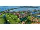 Stunning aerial view of a coastal community with lush landscaping, golf course, serene ponds, and stunning waterfront vistas at 6059 Bahia Del Mar Blvd # 134, St Petersburg, FL 33715