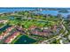 Expansive aerial view highlights the golf course and lake, complemented by well-maintained community buildings and lush landscaping at 6059 Bahia Del Mar Blvd # 134, St Petersburg, FL 33715