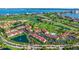 Panoramic aerial view of the community near a golf course and pond, displaying lush landscaping and convenient parking at 6059 Bahia Del Mar Blvd # 134, St Petersburg, FL 33715