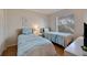 Charming bedroom featuring two twin beds, light-colored wood floors, and bright natural light at 6059 Bahia Del Mar Blvd # 134, St Petersburg, FL 33715