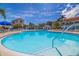 The community pool features crystal clear water, lounge chairs, and umbrellas for resident's relaxation at 6059 Bahia Del Mar Blvd # 134, St Petersburg, FL 33715