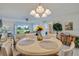 Charming dining area with golf course views, a decorative light fixture and seating for four at 6059 Bahia Del Mar Blvd # 134, St Petersburg, FL 33715