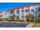 Condominium exterior shows a red tile roof, reserved parking and stairs to the second floor entrance at 6059 Bahia Del Mar Blvd # 134, St Petersburg, FL 33715