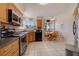 Bright eat-in kitchen has stainless steel appliances, breakfast nook, and tile flooring at 6059 Bahia Del Mar Blvd # 134, St Petersburg, FL 33715