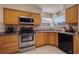 The kitchen has light wood cabinets, black appliances, and tile backsplash at 6059 Bahia Del Mar Blvd # 134, St Petersburg, FL 33715