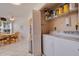 Convenient laundry area with washer, dryer, and storage shelves in a well lit room near the kitchen at 6059 Bahia Del Mar Blvd # 134, St Petersburg, FL 33715