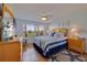 Bright bedroom with a bed, matching dressers, ceiling fan and golf course views from the window at 6059 Bahia Del Mar Blvd # 134, St Petersburg, FL 33715
