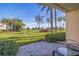 Relaxing patio view overlooking a lush green golf course with towering palm trees against a blue sky at 6059 Bahia Del Mar Blvd # 134, St Petersburg, FL 33715