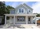 Charming two-story home with a covered front porch and light-blue siding, awaiting your personal touch at 615 48Th N Ave, St Petersburg, FL 33703