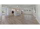 Open concept living space with wood-look floors, white kitchen with stainless appliances, and plenty of natural light at 615 48Th N Ave, St Petersburg, FL 33703