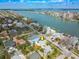 Scenic aerial view showcasing a yellow home surrounded by lush landscapes and waterfront views at 718 Bay Esplanade, Clearwater Beach, FL 33767