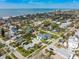 Aerial view of the yellow home showcasing its proximity to the beach and surrounding neighborhood at 718 Bay Esplanade, Clearwater Beach, FL 33767