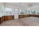 Renovation-ready living room with multiple windows, natural light, and exposed framework at 718 Bay Esplanade, Clearwater Beach, FL 33767